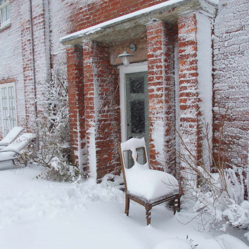 Chair in the wintery snow at Upper Heath Farm in South Shropshire